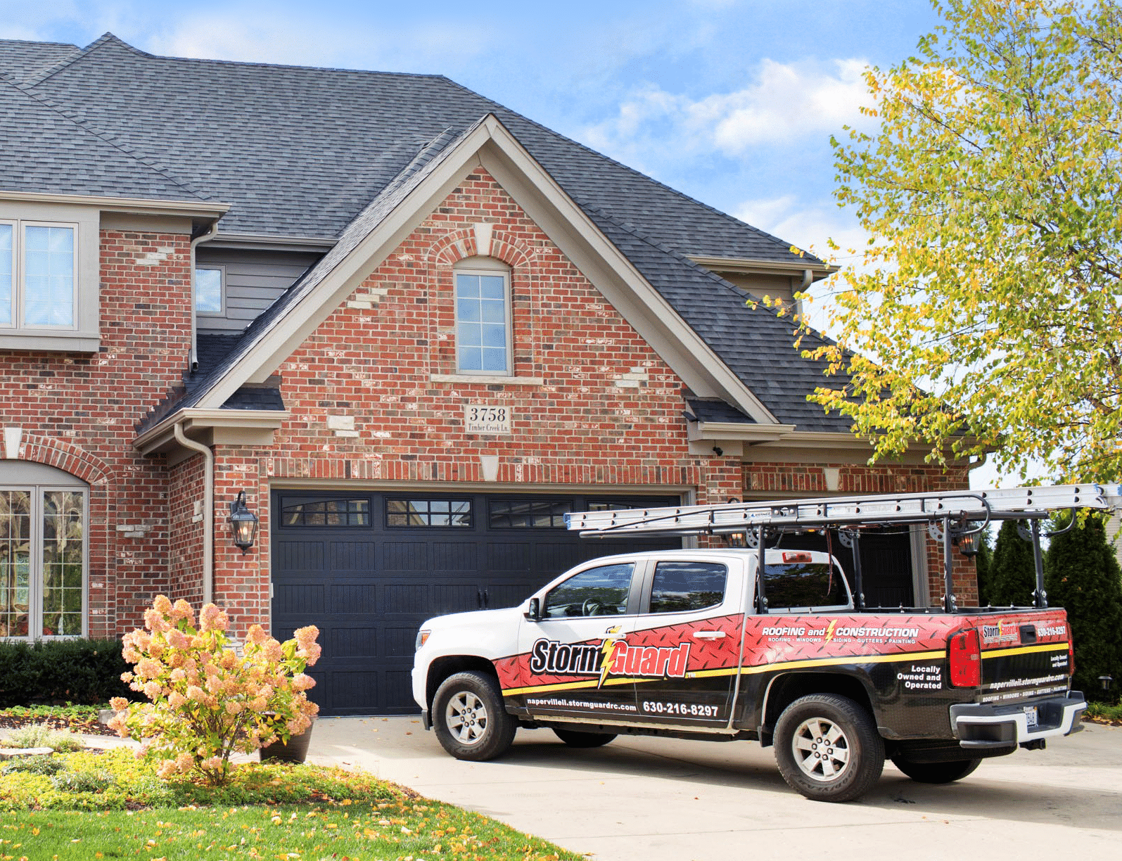Storm Guard Roofing of Madison truck at a local home