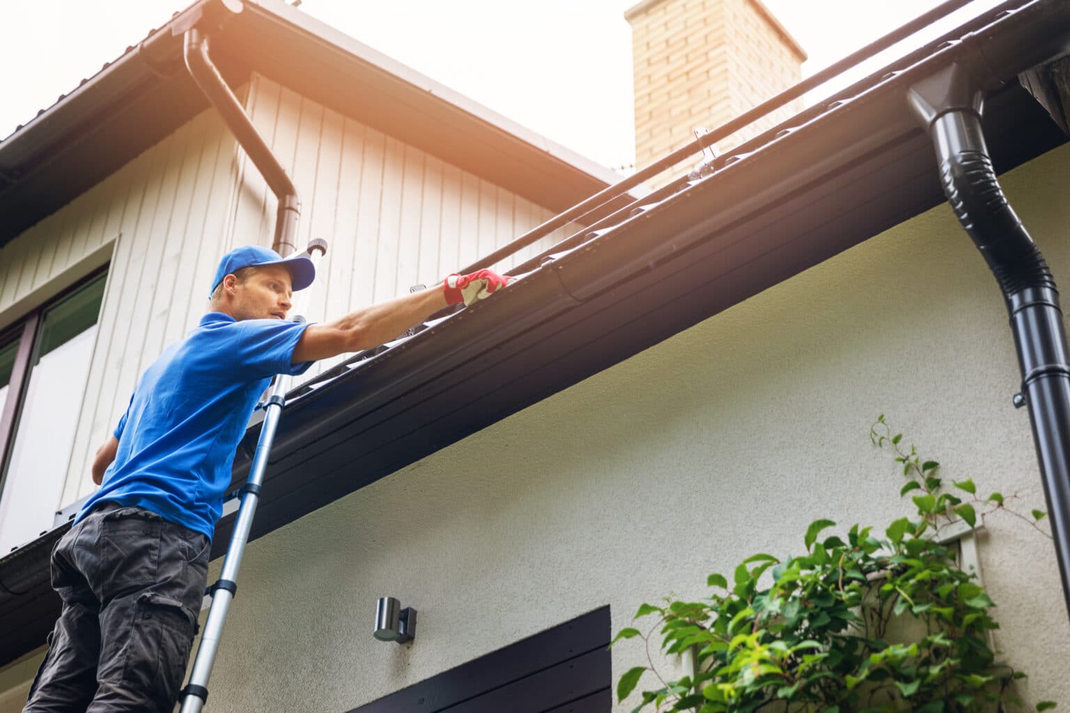 Storm Guard technician inspecting a Madison home's roofline and gutters